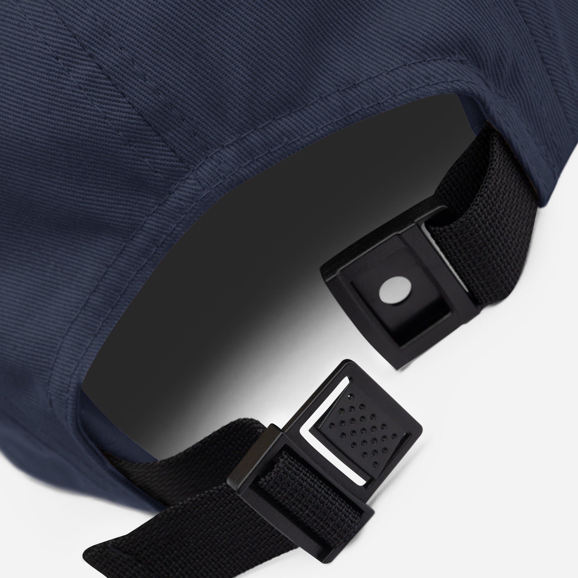 Close-up of navy Ratbag Moto Five Panel Cap adjustable strap buckle